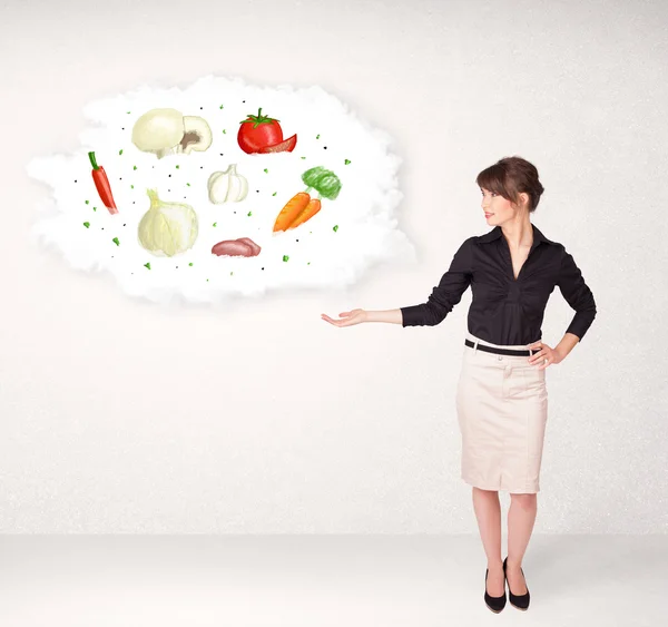 Young girl presenting nutritional cloud with vegetables — Stock Photo, Image