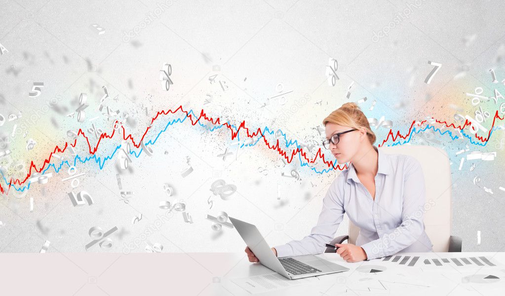 Business woman sitting at table with stock market graph 