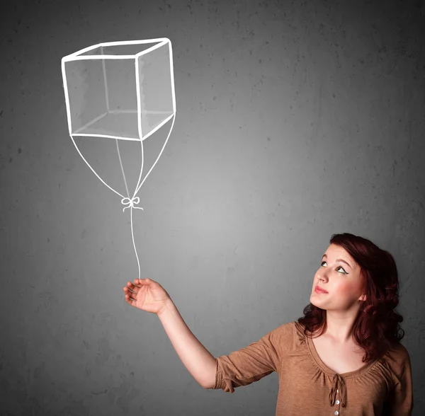 Vrouw met een kubus ballon — Stockfoto