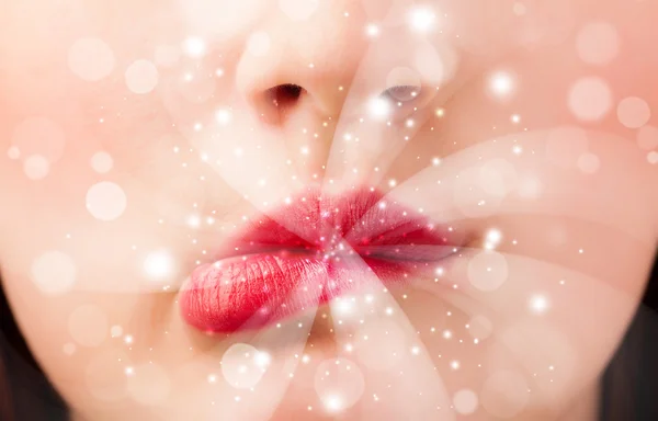 Mooie vrouw lippen blazen abstracte witte lichten — Stockfoto