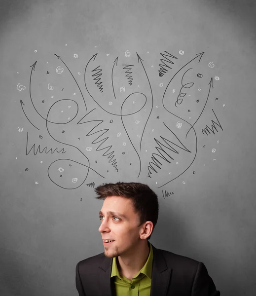 Businessman thinking with arrows over his head — Stock Photo, Image