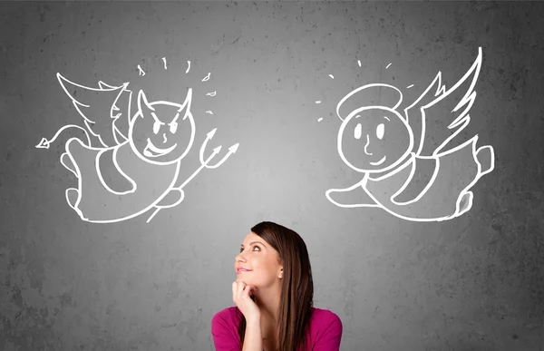 Woman standing between the angel and the devil — Stock Photo, Image