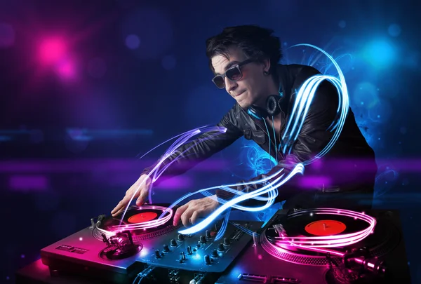 Disc jockey playing music with electro light effects and lights — Stock Photo, Image