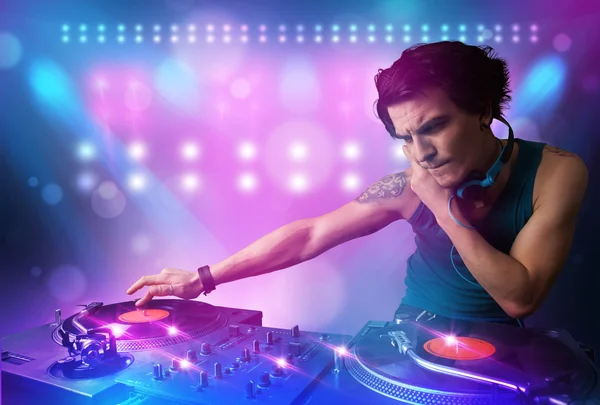 Disc jockey mixing music on turntables on stage with lights and — Stock Photo, Image