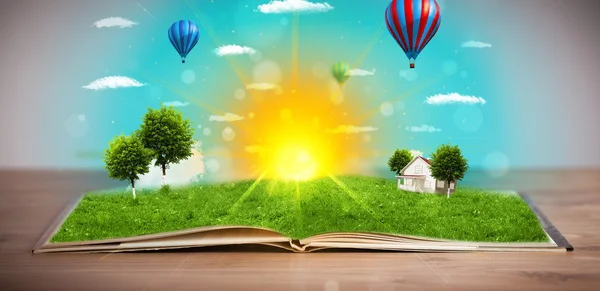 Open book with green nature world coming out of its pages — Stock Photo, Image