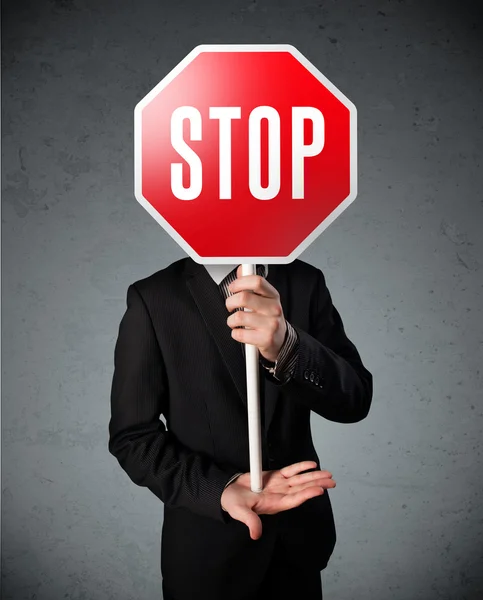 Businessman holding a stop sign — Stock Photo, Image