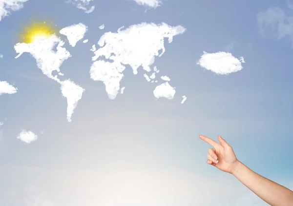 Hand pointing at world clouds and sun on blue sky — Stock Photo, Image