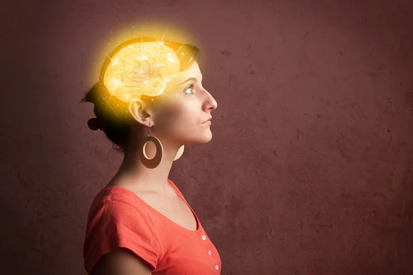 Young girl thinking with glowing brain illustration — Stock Photo, Image