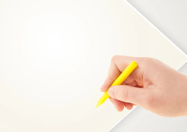 Child drawing with colorful crayon on empty blank paper — Stock Photo, Image