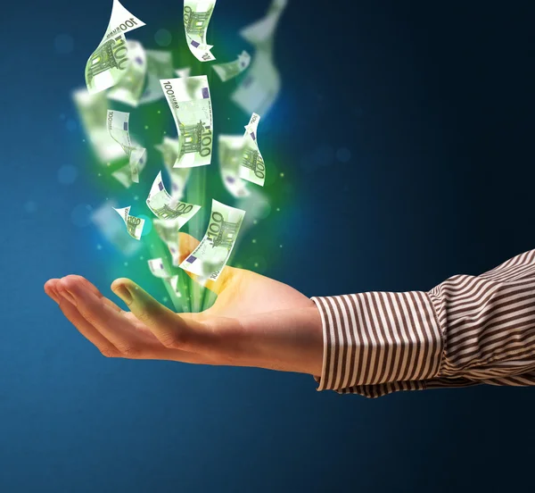 Glowing money in the hand of a businessman — Stock Photo, Image