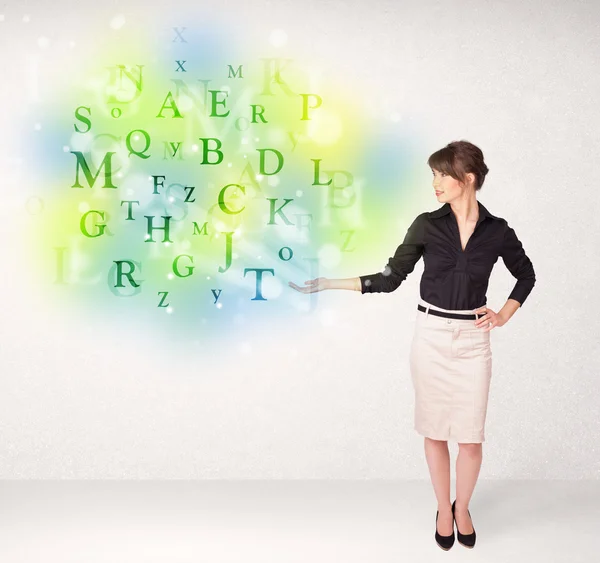 Business women with glowing letter concept — Stock Photo, Image