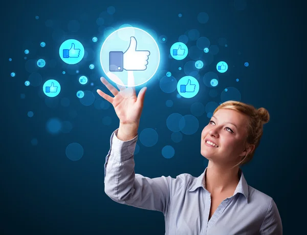 Young businesswoman pressing thumbs up button on modern social n — Stock Photo, Image