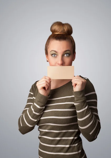 Cute girl holding white card at front of her lips with copy spac — Stock Photo, Image