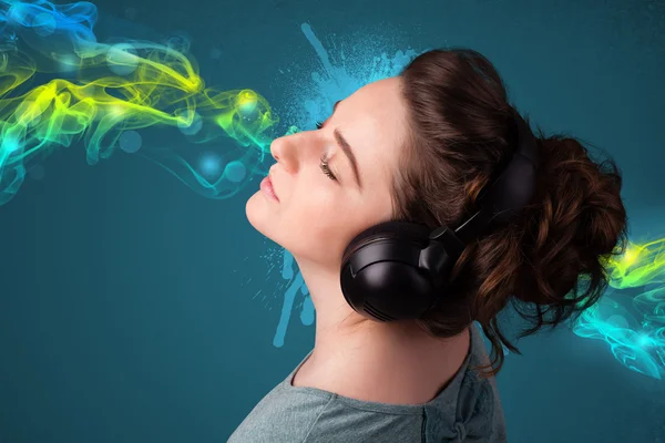 Mladá žena poslouchá hudbu se sluchátky — Stock fotografie