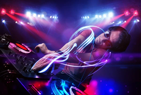 Disc jockey playing music with light beam effects on stage — Stock Photo, Image