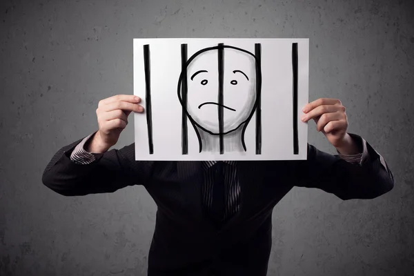 Businessman holding a paper with a prisoner behind the bars on i — Stock Photo, Image