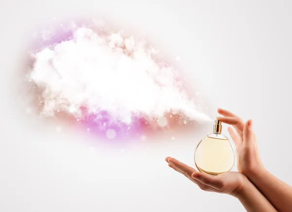 Woman hands spraying colorful cloud — Stock Photo, Image