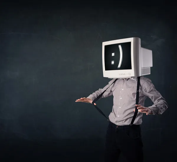 Funny young businessman with a monitor on his head and smiley on — Stock Photo, Image