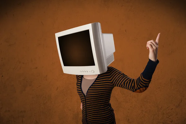 Girl with a monitor on her head and empty brown copyspace — Stock Photo, Image