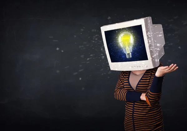 Girl with a monitor head, idea light bulb on the display — Stock Photo, Image