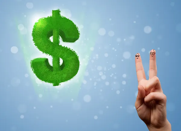 Happy smiley fingers looking at green leaf dollar sign — Stock Photo, Image