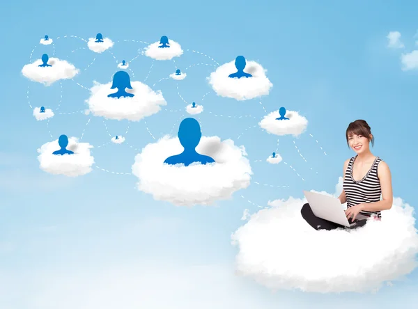 Young woman sitting in cloud with laptop — Stock Photo, Image