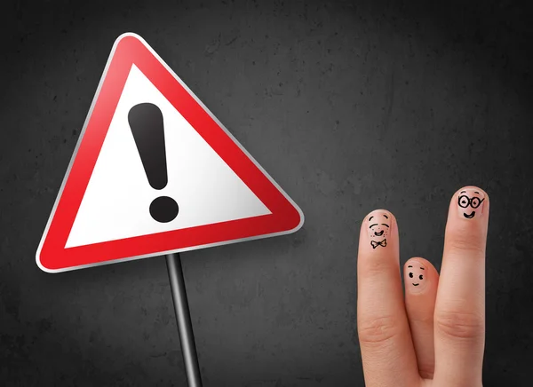 Happy smiley fingers looking at triangle warning sign with excla — Stock Photo, Image