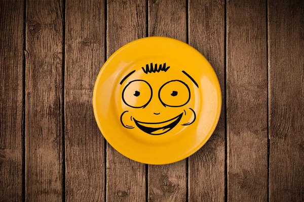 Happy smiley cartoon face on colorful dish plate — Stock Photo, Image