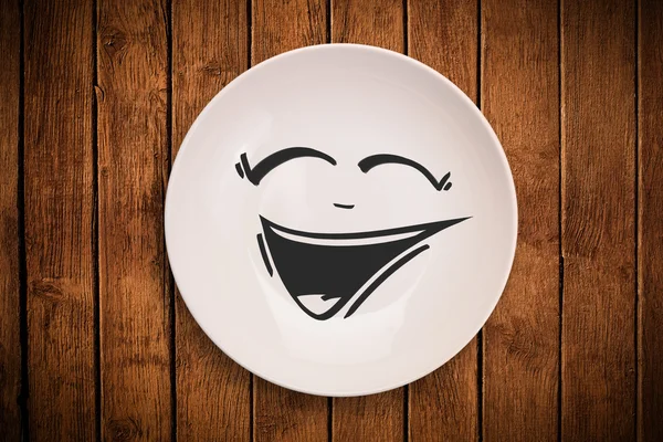 Happy smiley cartoon face on colorful dish plate — Stock Photo, Image