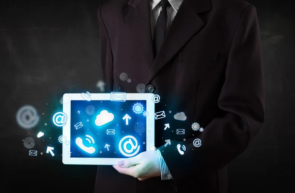 Person holding a tablet with blue technology icons and symbols — Stock Photo, Image