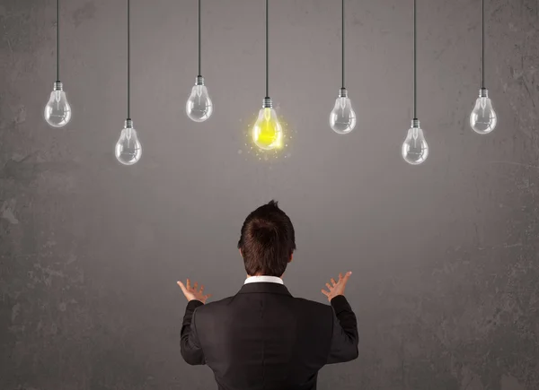 Businness guy in front of idea light bulbs concept — Stock Photo, Image
