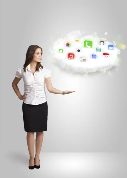 Young woman presenting cloud with colorful app icons and symbols — Stock Photo, Image