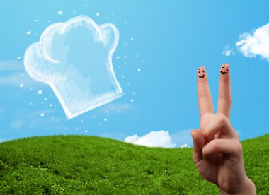 Mutlu gülen yüzlü parmaklar aşçı şapkasının resmine bakıyor.
