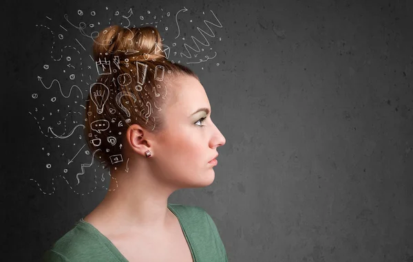 Mladá dívka přemýšlí s abstraktními ikonami na hlavě — Stock fotografie