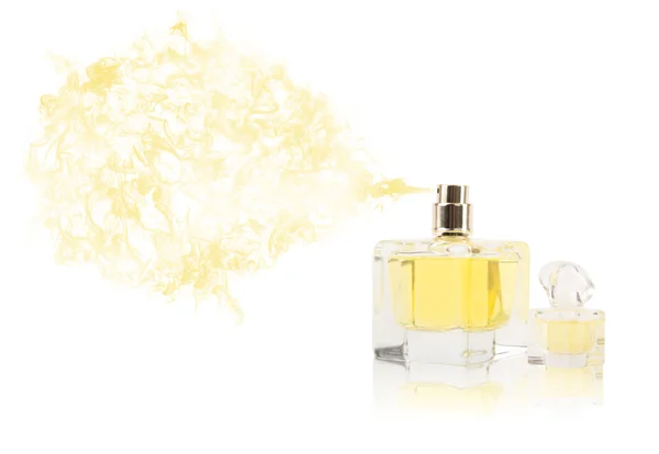 Perfume bottle spraying colored scent — Stock Photo, Image