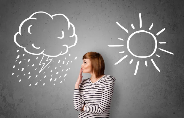 Woman standing between a sun and a rain drawing — Stock Photo, Image