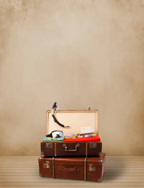 Retro tourist luggage with colorful clothes and copyspace — Stock Photo, Image