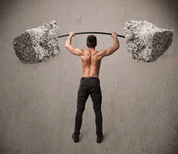 Muscular man lifting large rock stone weights — Stock Photo, Image