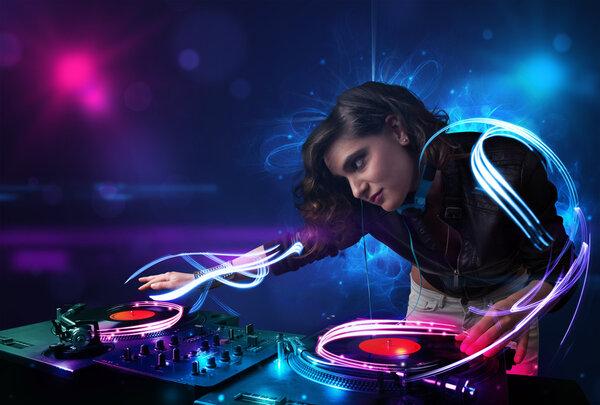 Disc jockey playing music with electro light effects and lights