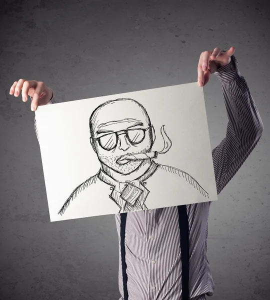 Businessman holding a cardboard with a smoking man on it in fron — Stock Photo, Image