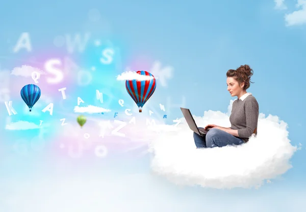 Young woman sitting in cloud with laptop — Stock Photo, Image