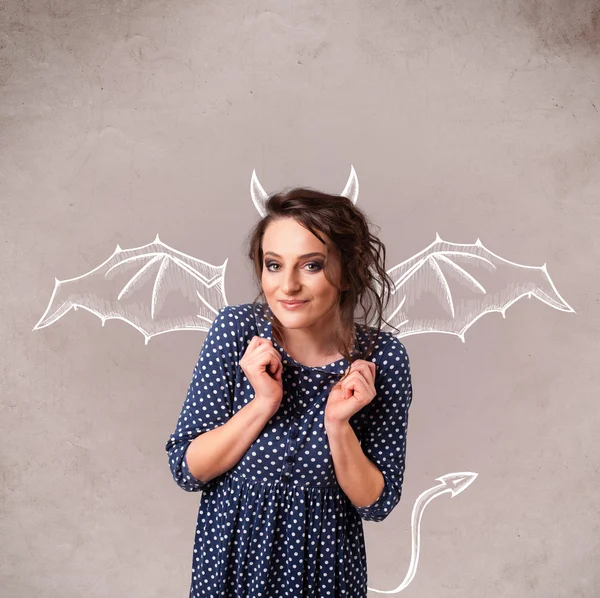 Young girl with devil horns and wings drawing — Stock Photo, Image