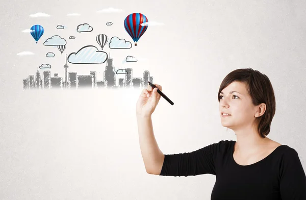 Pretty woman sketching cityscape with colorful balloons — Stock Photo, Image
