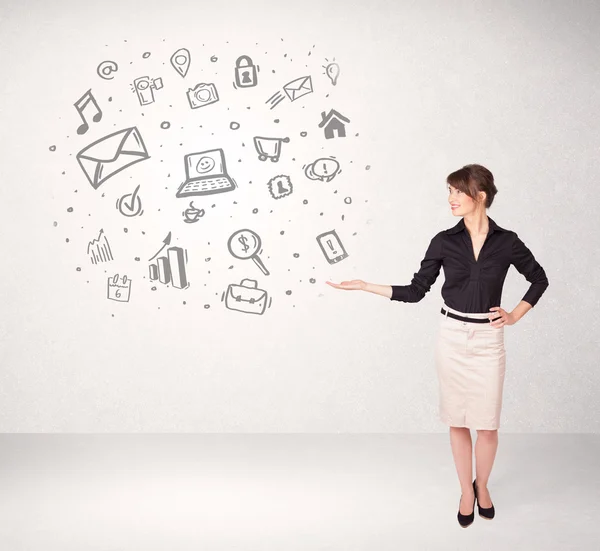 Young business woman presenting hand drawn media icons — Stock Photo, Image