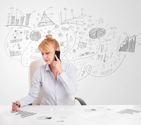 Business woman at desk with hand drawn charts — Stock Photo, Image