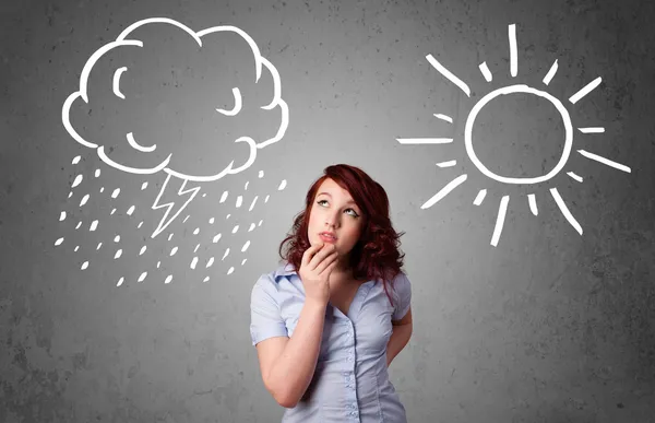 Woman standing between a sun and a rain drawing — Stock Photo, Image