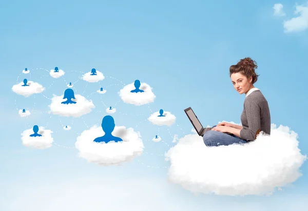 Young woman sitting in cloud with laptop — Stock Photo, Image