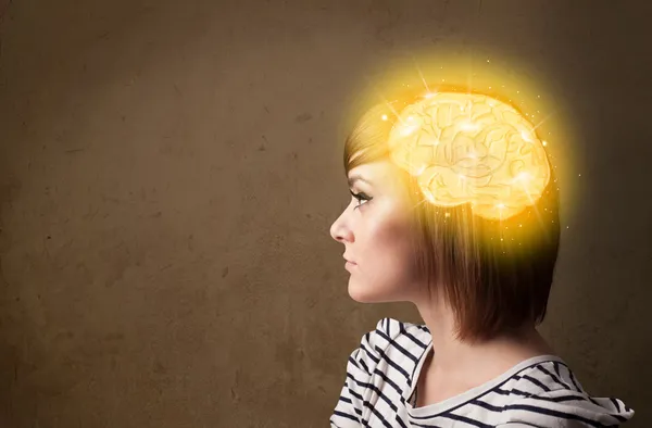 Young girl thinking with glowing brain illustration — Stock Photo, Image