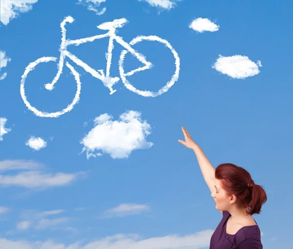 Young girl looking at bicycle clouds on blue sky — Stock Photo, Image