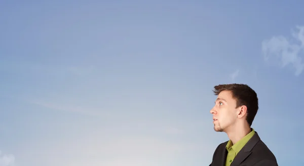 Handsome man looking at the blue sky copyspace — Stock Photo, Image